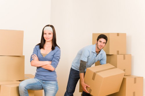 A professional team carefully packing household items in North London